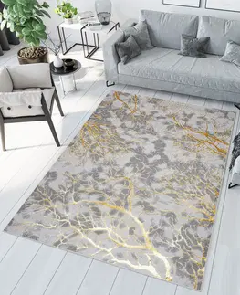 Moderní koberce Jednoduchý moderní koberec v šedé barvě se zlatým motivem