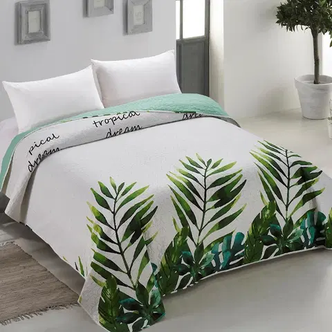 Luxusní oboustranné přehozy na postel Prošívaný oboustranný přehoz na postel s tropickým motivem
